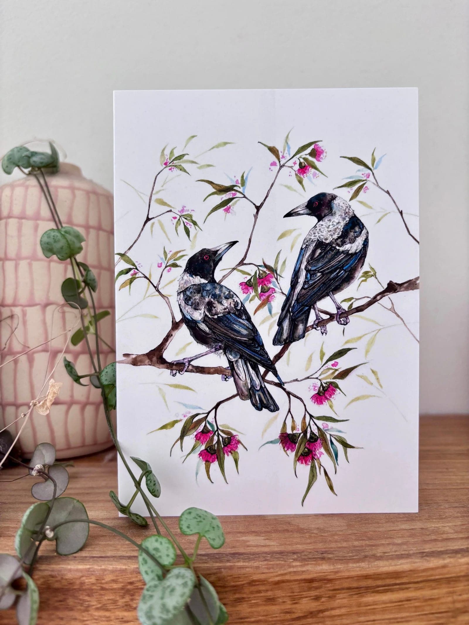 Magpie greeting card styled on a timber surface