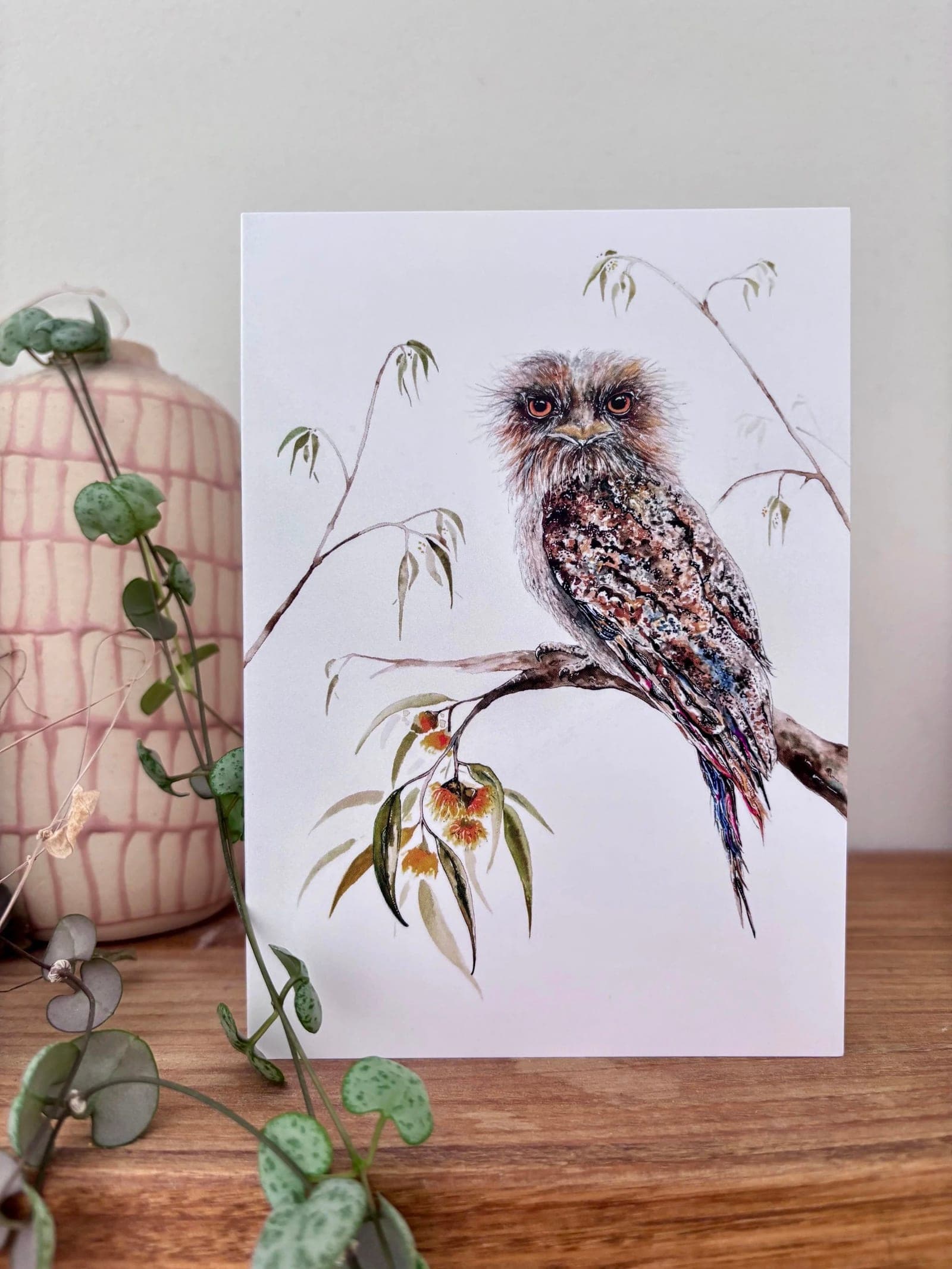 Tawny frogmouth greeting card styled with foliage